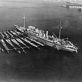 AS 3 USS_Holland_with_seven_submarines_alongside_at_San_Diego,_California_on_24_December_1934.jpg